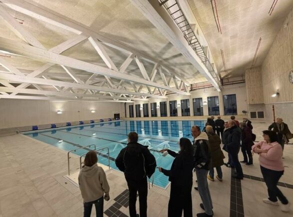 Innbyggere står og ser på det nye bassenganlegget